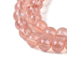 Pyöreähkö lasihelmi läpikuultava hohdepintaväri n. 6 mm tumma persikka 25 kpl