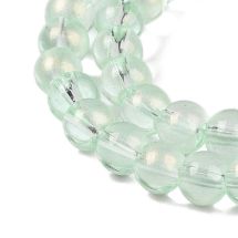 Pyöreähkö lasihelmi läpikuultava hohdepintaväri n. 6 mm vaalea peridootti 25 kpl